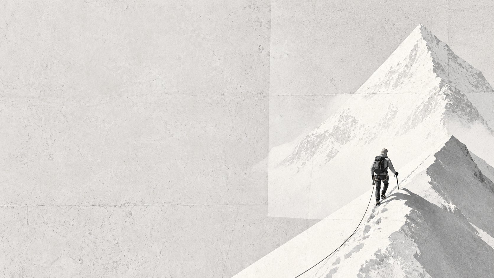 A climber roped up on a snowy ridge toward a peak